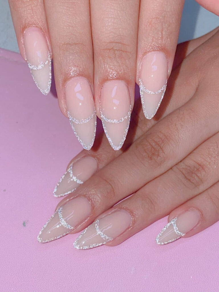 Long acrylic nails with glitter and almond shape